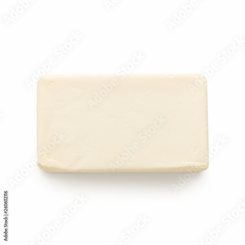 Block of butter on white