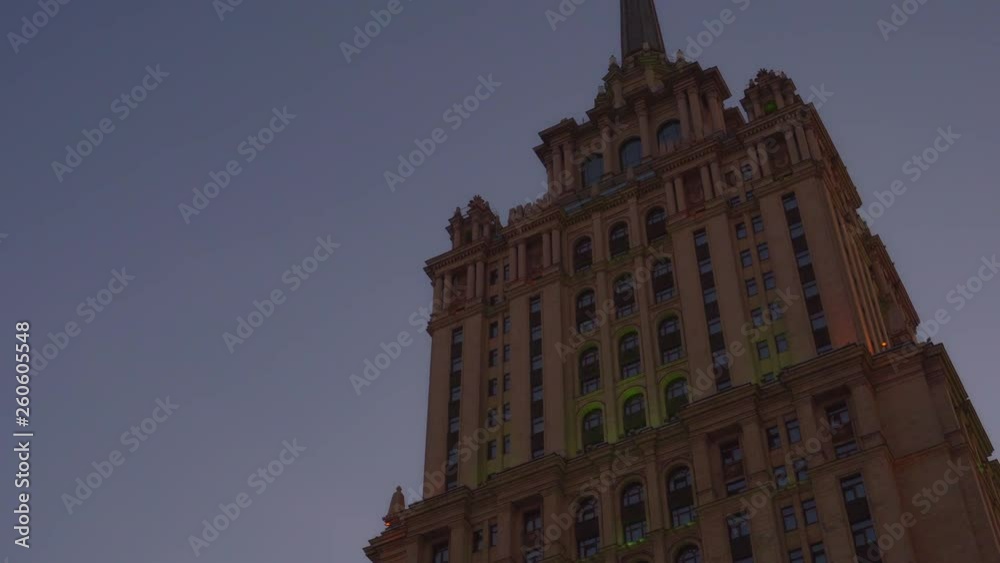 Beautiful old building. One of the seven skyscrapers built by Stalin order in Moscow. The image slides down the building and back. Side and bottom view. Evening. Art Deco style. The original facade