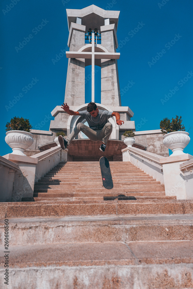 Skater doing an ollie trick at the church skateboard god skate jesus Photos  | Adobe Stock