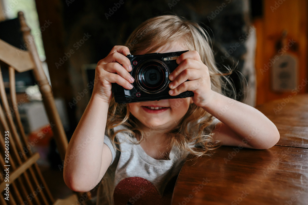 toddler girl learning how to take pictures with a camera toddler girl learning how to take pictures with a camera