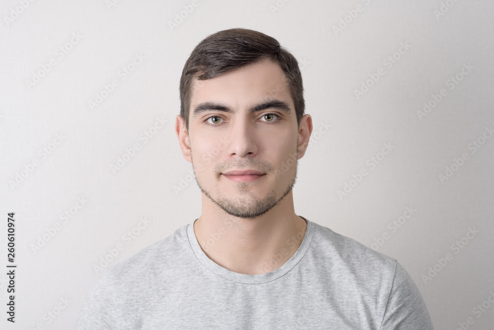 portrait of dark-haired man on light background portrait of dark-haired man on light background