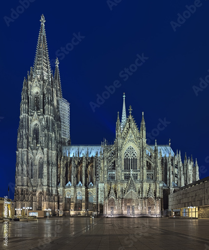 Cologne Cathedral at dusk, Germany. Construction of the Cathedral began in 1248. Currently it is the tallest twin-spired church at 157 m (515 ft) tall. photo