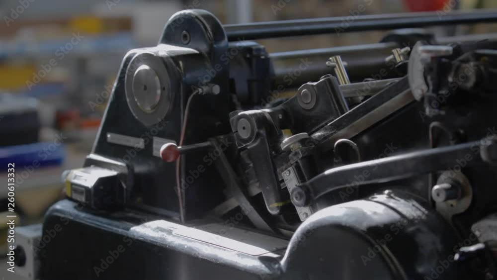 REAL TIME: Metal industrial printer machine works at a print house REAL TIME: Metal industrial printer machine works at a print house