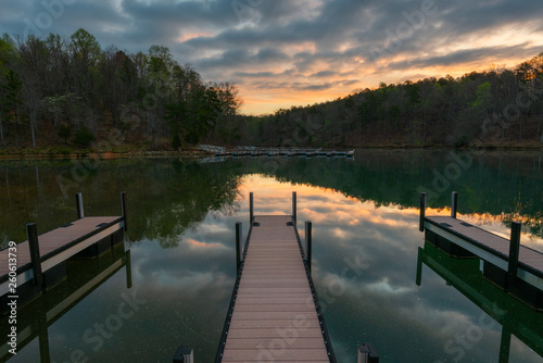 docks on lake during sunrise with reflection