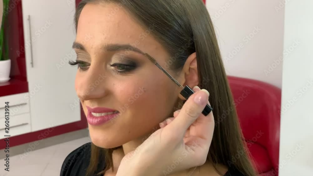 Beauty salon. Young beautiful girl model sitting in the chair. Makeup artist makes makeup girls Beauty salon. Young beautiful girl model sitting in the chair. Makeup artist makes makeup girls