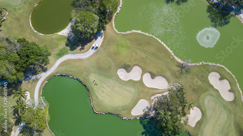 Golf course with gorgeous green and pond. Aerial view of a beautiful green golf course photo