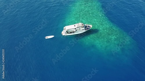 Drone pulling away from Dive Boat on Coral Reef photo