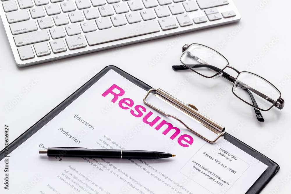 Create CV concept with pen, glasses, keyboard on white desk top view Create CV concept with pen, glasses, keyboard on white desk top view
