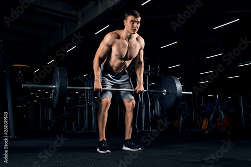 Athlete training with barbell in a gym - Functional, crossfit, workout concept