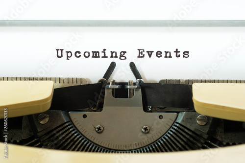Upcoming Events word typed on a yellow vintage typewritter. Business concept.