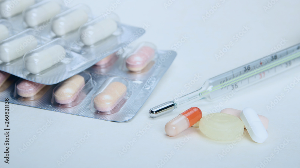 Pharmacy theme, tablets, pills capsule heap mix therapy drugs with medicine antibiotic and thermometer. Close up of capsules. Medicine background for medical concept. Pharmacy theme, tablets, pills capsule heap mix therapy drugs with medicine antibiotic and thermometer. Close up of capsules. Medicine background for medical concept.