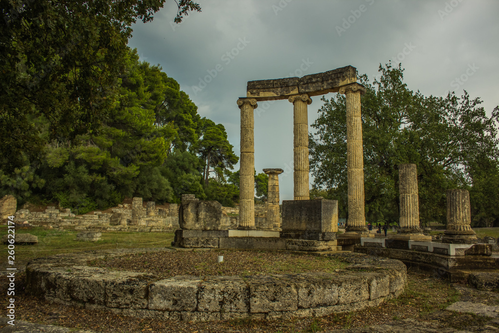 abandoned antique marble architecture building colonnade forum from ancient Greece times in park outdoor famous touristic heritage site for sightseeing and travel in Peloponnese peninsula 