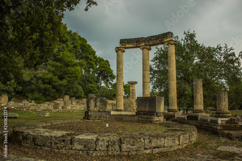 abandoned antique marble architecture building colonnade forum from ancient Greece times in park outdoor famous touristic heritage site for sightseeing and travel in Peloponnese peninsula 