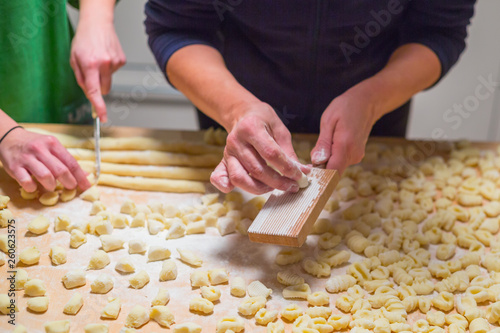 Cooks hands preparing raw pumpkin gnocchi  photo