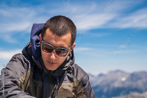 Man Traveler on mountain summit enjoying aerial view hands raised over clouds Travel Lifestyle success concept adventure active vacations outdoor happiness freedom emotions