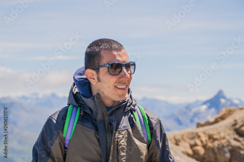 Man Traveler on mountain summit enjoying aerial view hands raised over clouds Travel Lifestyle success concept adventure active vacations outdoor happiness freedom emotions