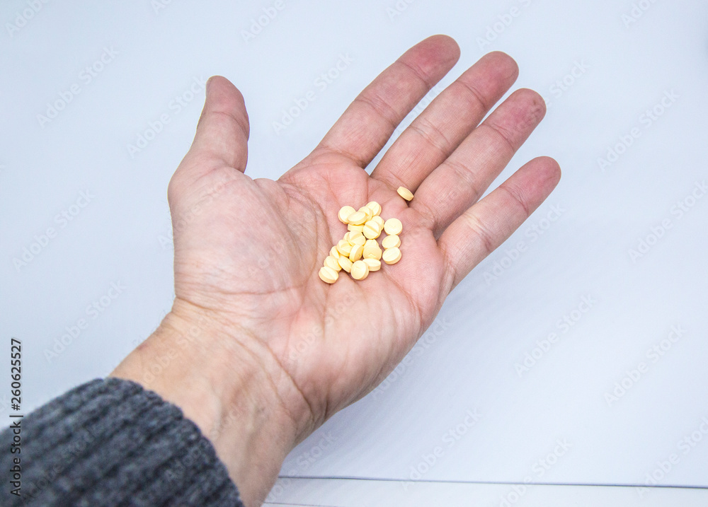 Medicine pills or capsules in elder hand Medicine pills or capsules in elder hand