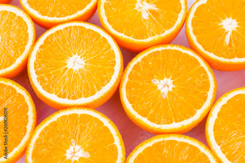 Background of oranges fruits. Many halves of fresh oranges, top view. Citrus for making juice. A lot of sliced oranges on white background. Concept