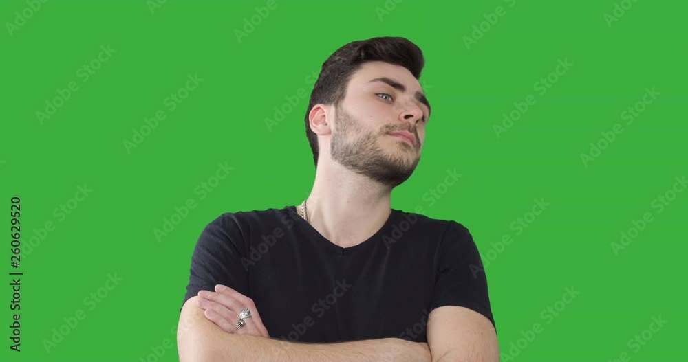 Handsome man looking away against green screen Handsome man looking away against green screen