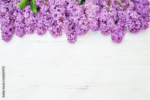 Floral pattern of lilac branches, flowers background. Flat lay, top view.