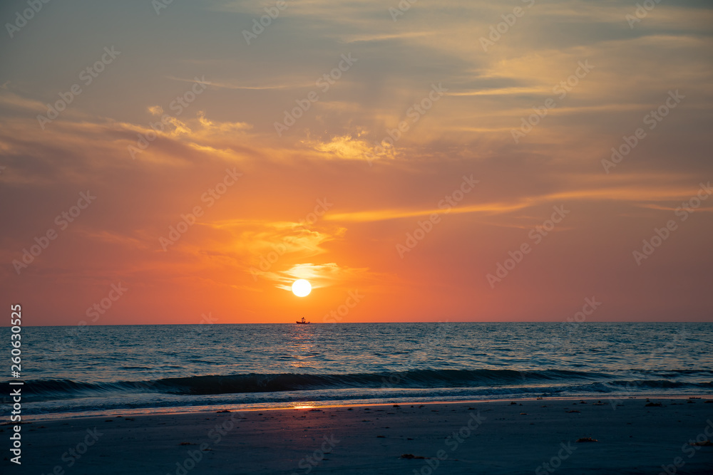 Beach at sunset with a orange sky
