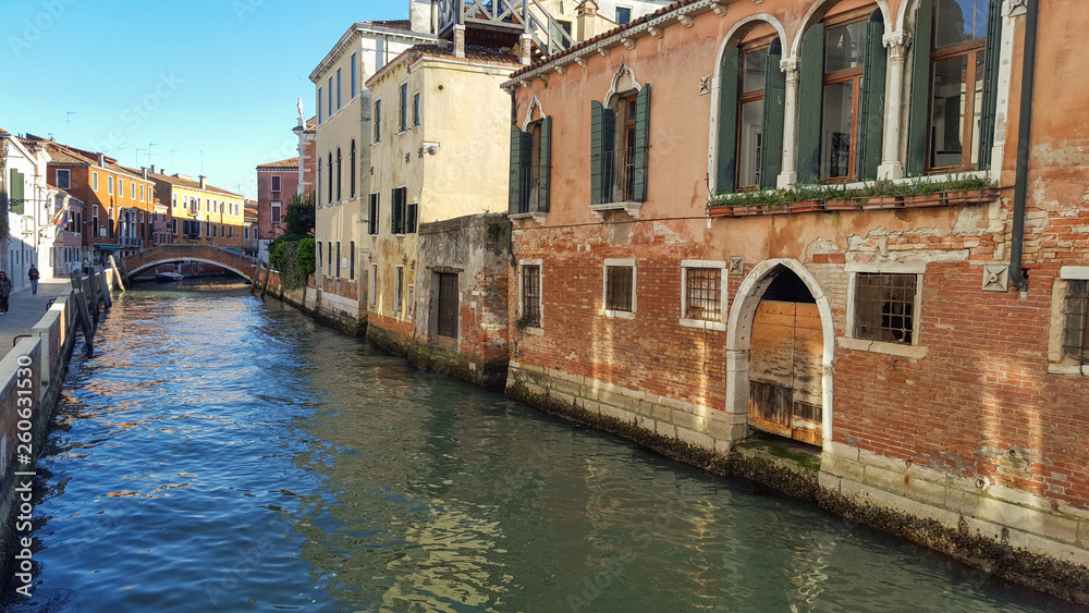 Classical picture of venetian canals with boats across canal. Venice, Italy ,march , 2019