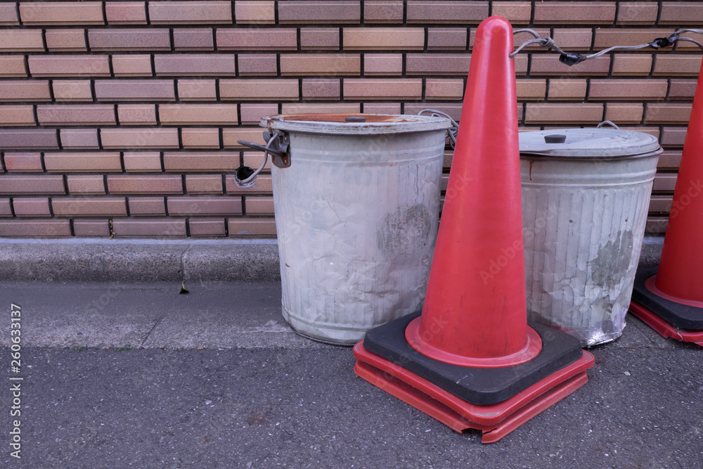 Garbage cans and cones by the wall Garbage cans and cones by the wall