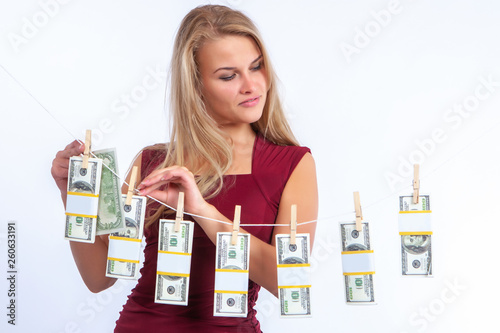 The girl hangs up dollars. ...