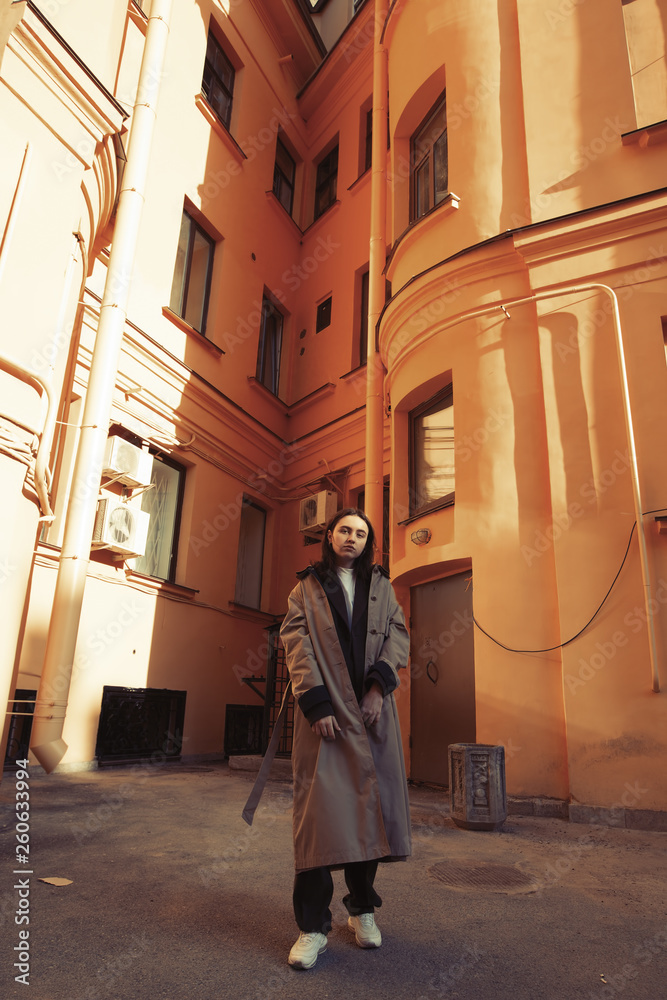 Attractive girl posing in the yard in a European city.