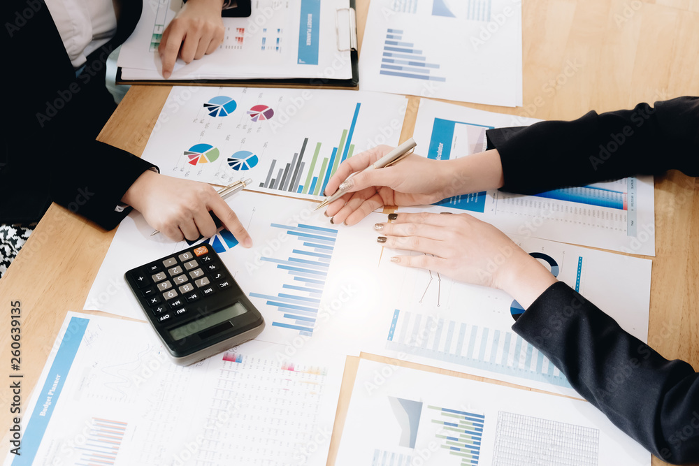 Business People Meeting using calculator,stock market chart paper for analysis Plans to improve quality next month. Conference Discussion Corporate Concept Business People Meeting using calculator,stock market chart paper for analysis Plans to improve quality next month. Conference Discussion Corporate Concept