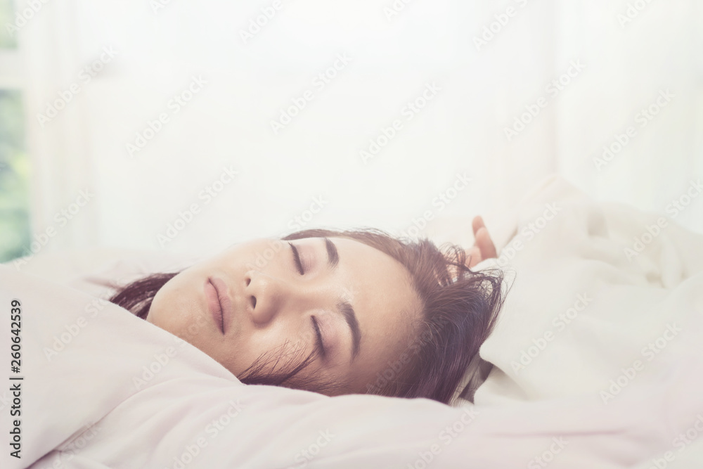Asian woman sleep on white pillow on bed in bedroom in holiday.happy relax time Asian woman sleep on white pillow on bed in bedroom in holiday.happy relax time