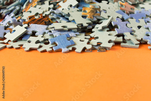 Abstract background of many different puzzles. The concept of teamwork. Selective focus.