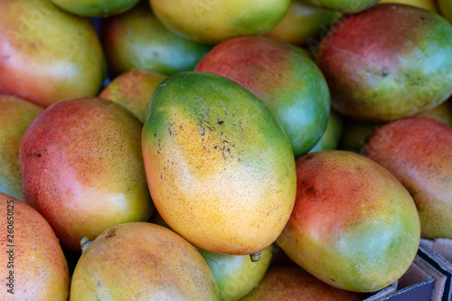 Fresh colorful tropical mangoes on display at outdoor farmers market at little India, street market, Singapore , closeup, mango background