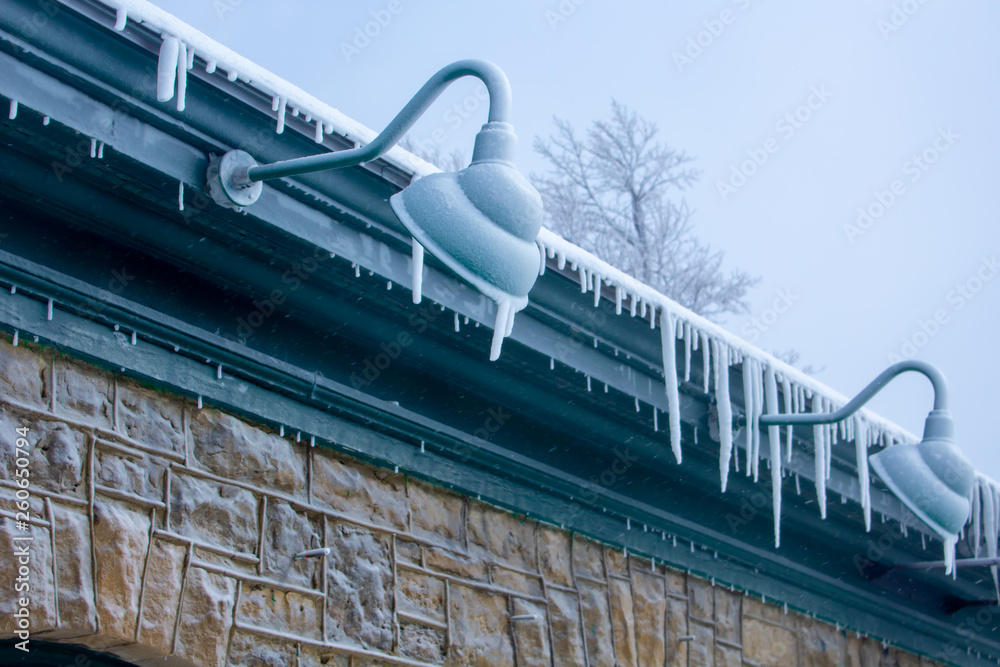 Frozen ice on roof and lamp