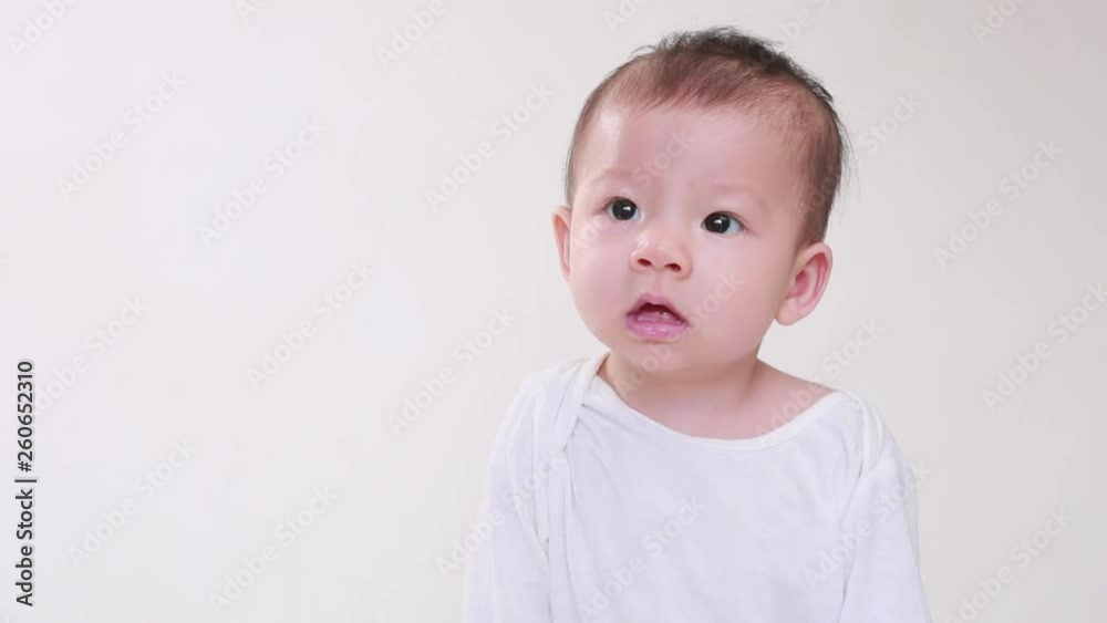Portrait of little asian baby girl smilling in the white background, happy family concept Portrait of little asian baby girl smilling in the white background, happy family concept