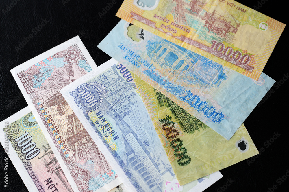 Vietnamese dong bills on a dark background close up. Money background Vietnamese dong bills on a dark background close up. Money background