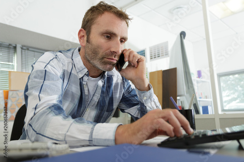 businessman talking by phone in office