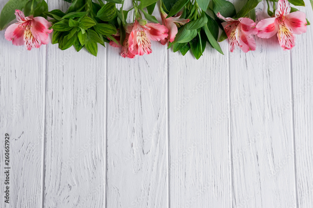 Background for text banner on a dark wooden background with white flowers. Blank, frame for text. Greeting card design with flowers. Aalstroemeria on wooden background. View from above