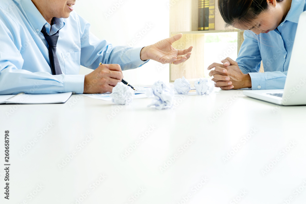 Fototapeta premium businessman and businesswoman sit quarrel at the table