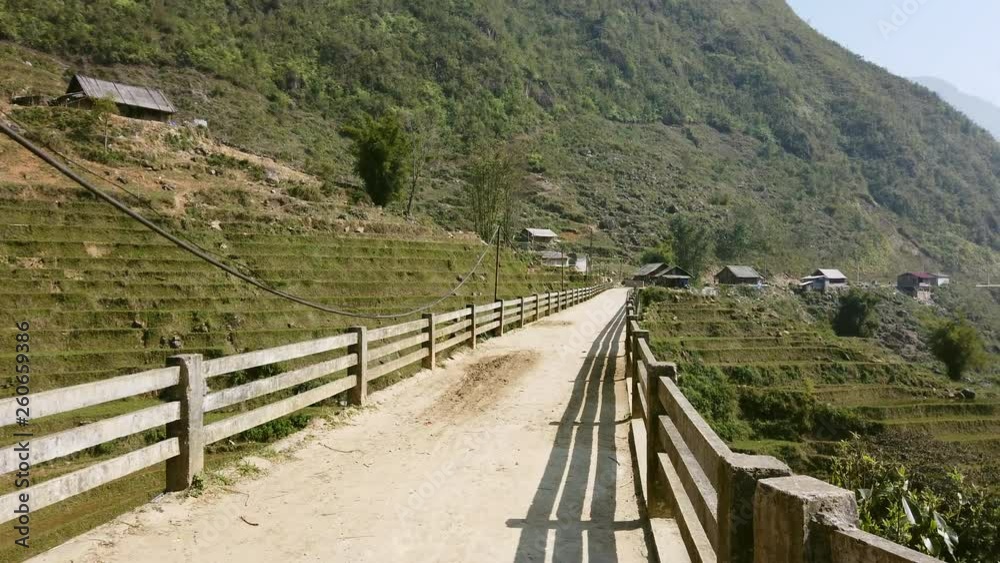 Riding on to an old bridge with rice fields on hills in the background, SAPA, Vietnam, shot on gimbal 4K Riding on to an old bridge with rice fields on hills in the background, SAPA, Vietnam, shot on gimbal 4K