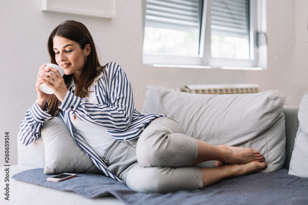 Girl enjoying her coffee at home. Woman drinking morning coffee at her cozy home. Girl enjoying her coffee at home. Woman drinking morning coffee at her cozy home.