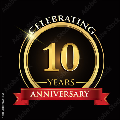 Celebrating 10 years anniversary logo. with golden ring and red ribbon.