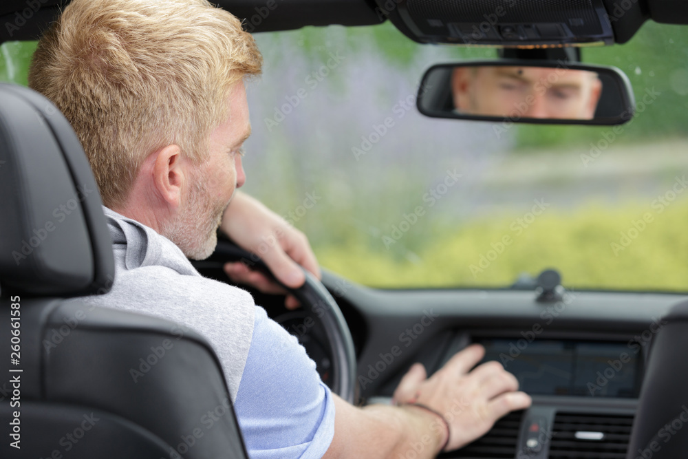 male driver using touchscreen in car male driver using touchscreen in car