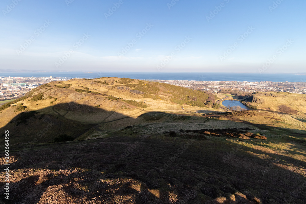 Obraz premium EDINBURGH, SCOTLAND, 20 February 2019, Cityscape of Edinburgh from Arthur's seat in beautiful February sunny day. Edinburgh, the most popular tourist city destination in Scotland