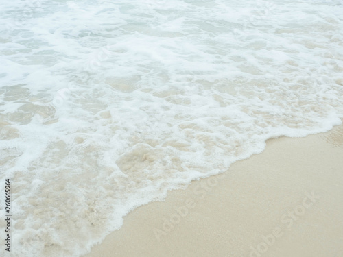 Sea water wave and water foam on beach background