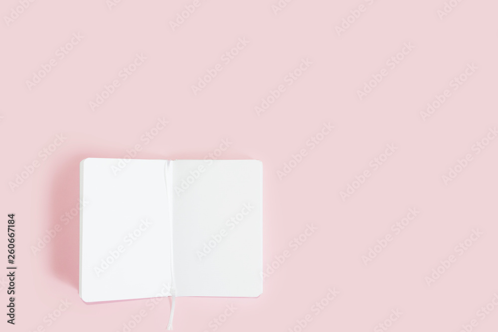 unfolded notebook with white sheets on a pink background unfolded notebook with white sheets on a pink background