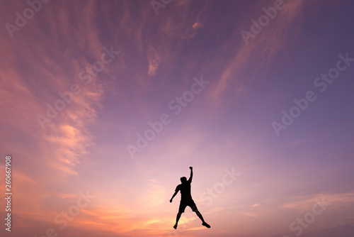 Canvas-taulu Silhouette of jumping man on sunrise background
