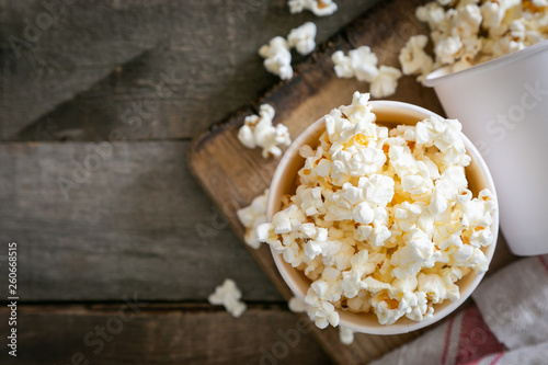 Home made pop corn in white cups on wood background
