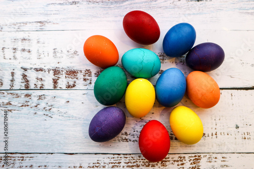 Several colorful easter eggs on wooden table background