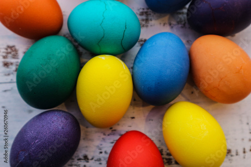several colorful easter eggs on the wooden table closeup